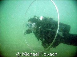 Student swimming through the hoops during a performance b... by Michael Kovach 